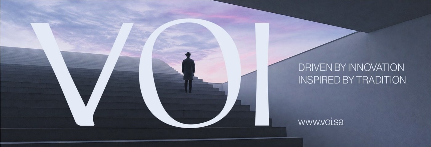 VOI billboard: oversized letters over a man on concrete stairs at dusk